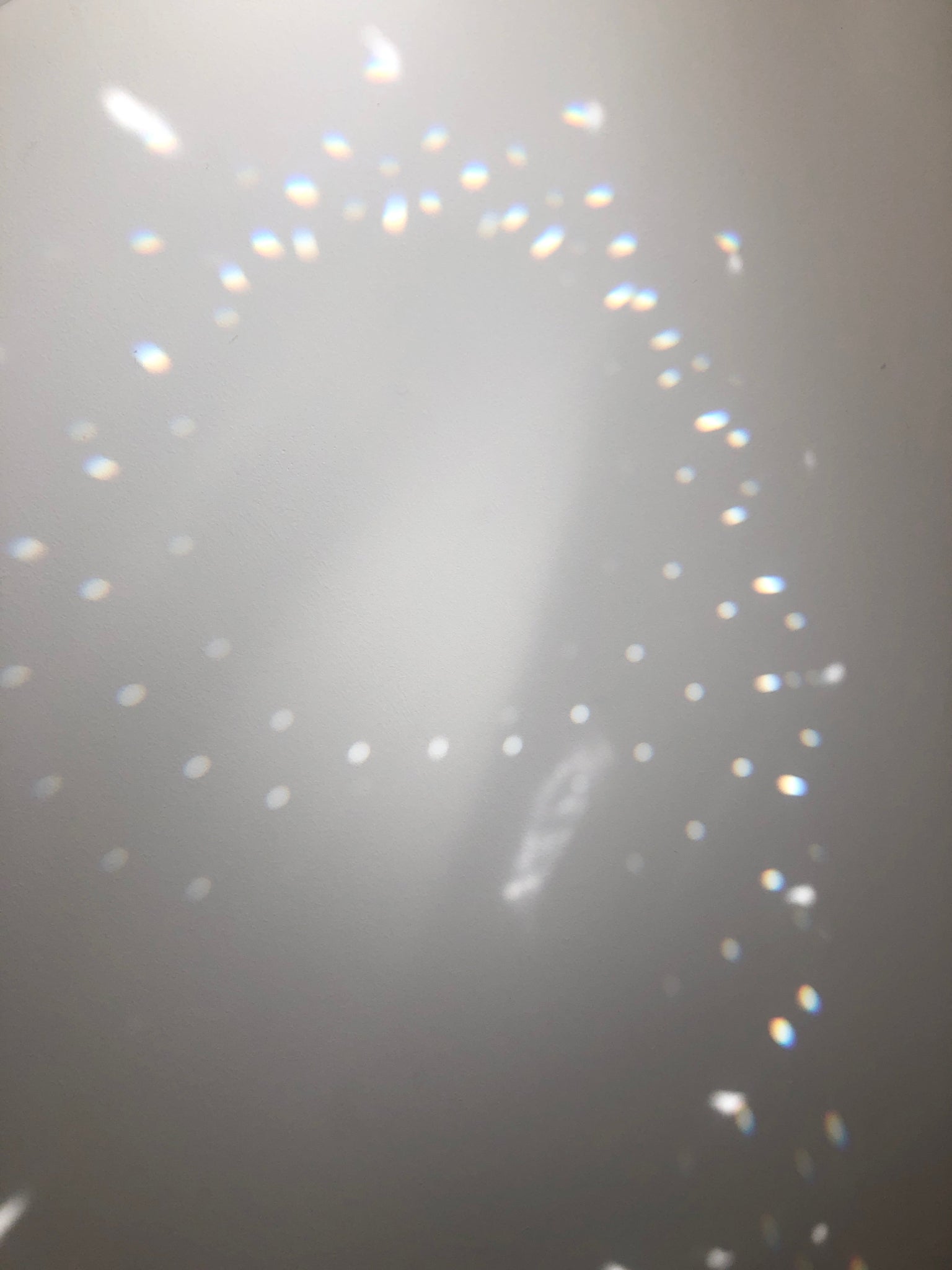 Holographic glittery texture on a gray background